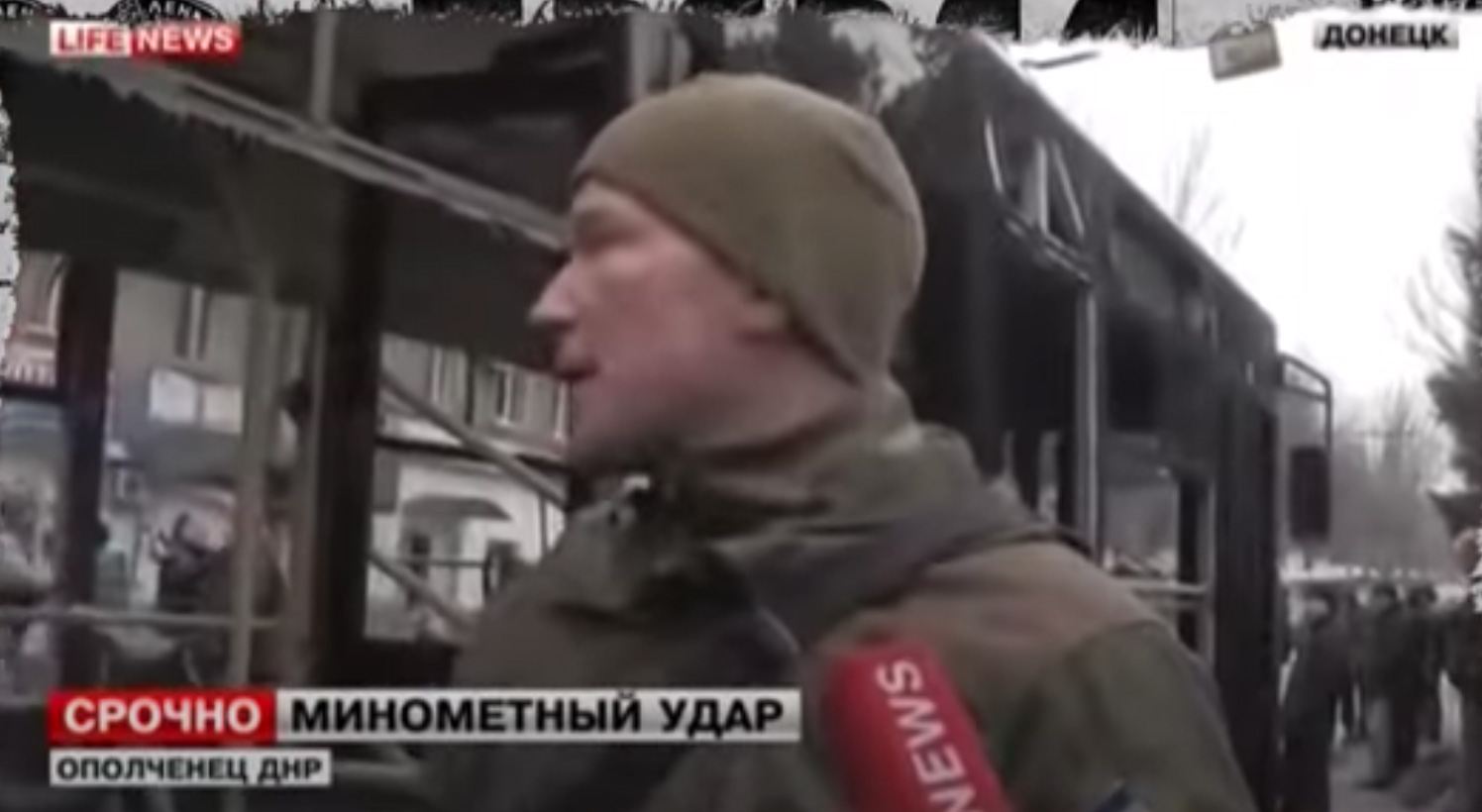 Russian propagandists from the Life News channel rehearse a disinformation plot at the site of shelling of the Donetsk Girmash transport stop in Donetsk on January 22, 2015